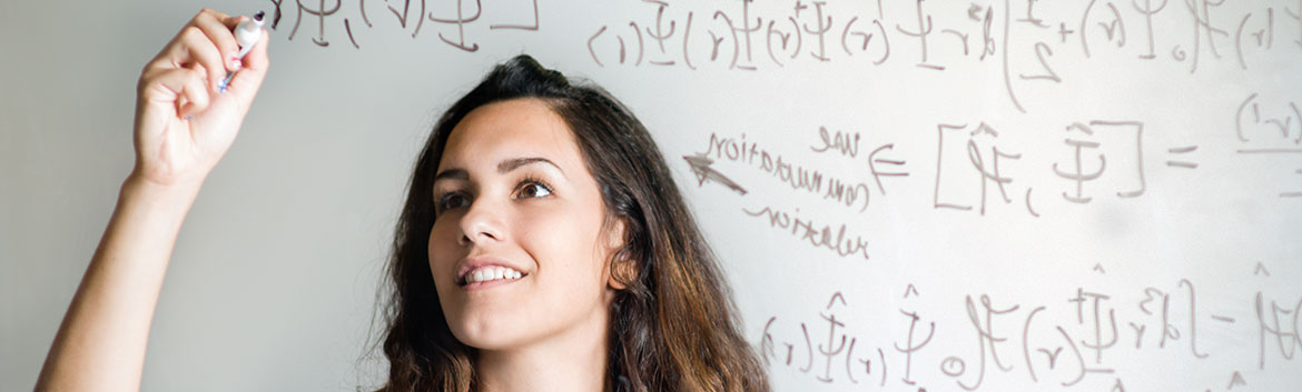 Physics student writing on a white board