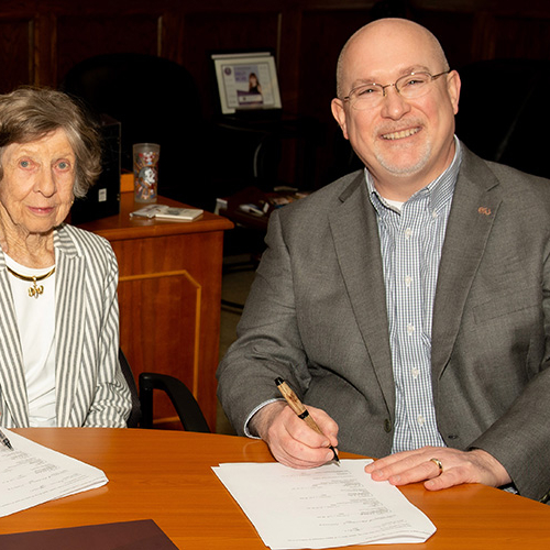 Mary W. Solomon with Michael Hartline during a signing ceremony