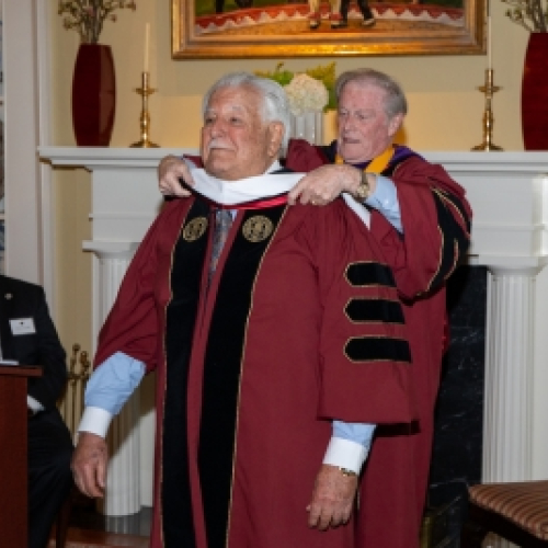 President Thrasher bestowing the honorary stole on Dr. Hold