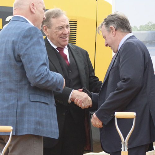Three men, FSU President Richard McCullough, U.S. Rep. Neal Dunn  and TMH President and CEO Mark O’Bryant, standing in front of construction equipment shaking hands